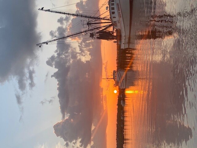 Marina with docked boat and sunset